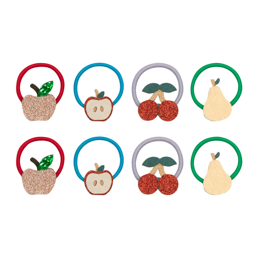 Set of fruit-themed hair ties on a white background
