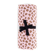 Folded fabric with leopard print and black ribbon on a white background