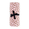 Folded fabric with leopard print and black ribbon on a white background