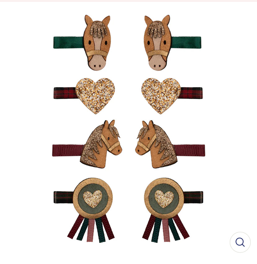 Set of horse-shaped hair clips with decorative elements on a white background