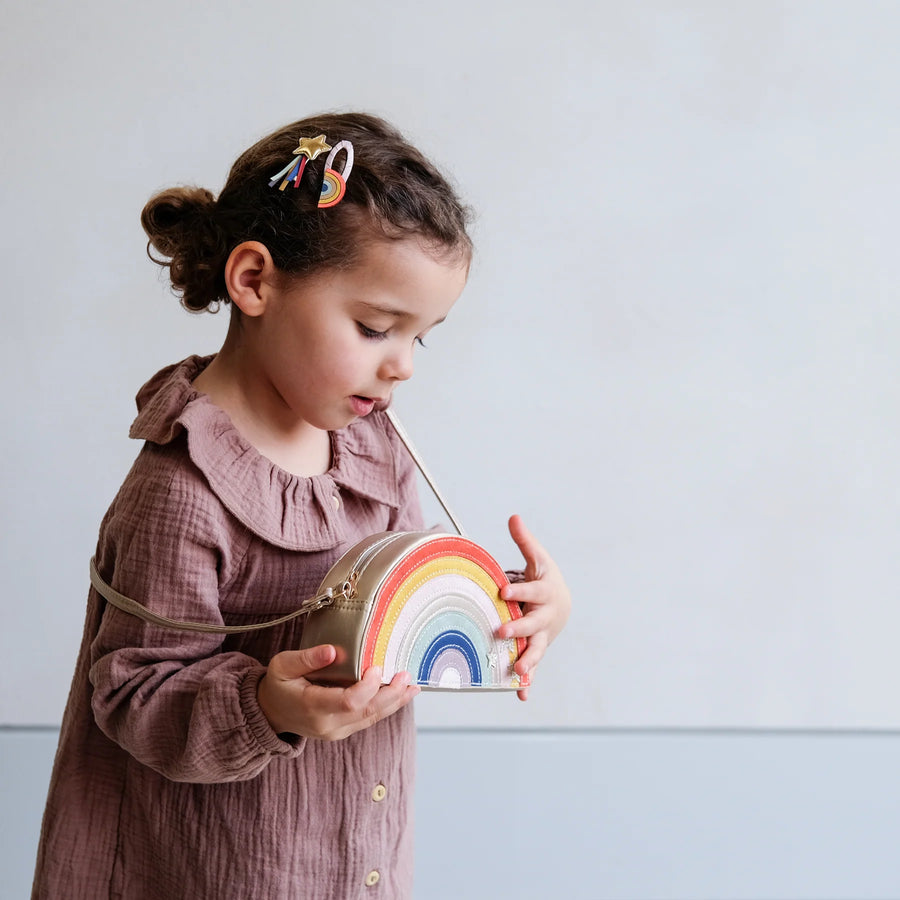 Over_the-rainbow_clips_in_hair_with_girl_holding_rainbow_bag